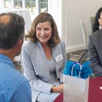 faculty engaging in conversation at their table